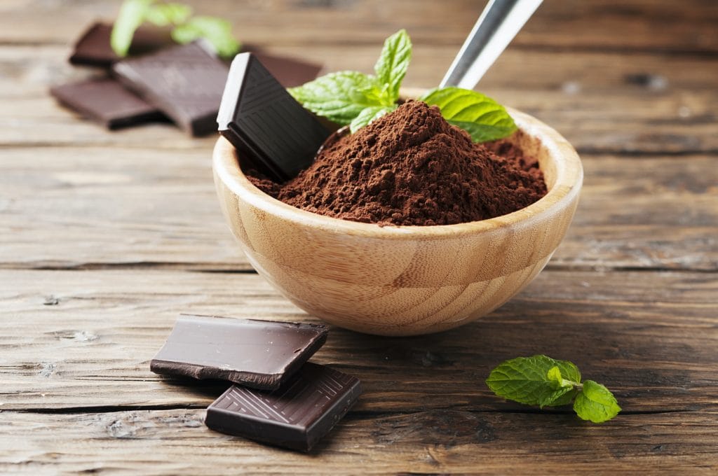 Dark chocolate and cocoa on the wooden table