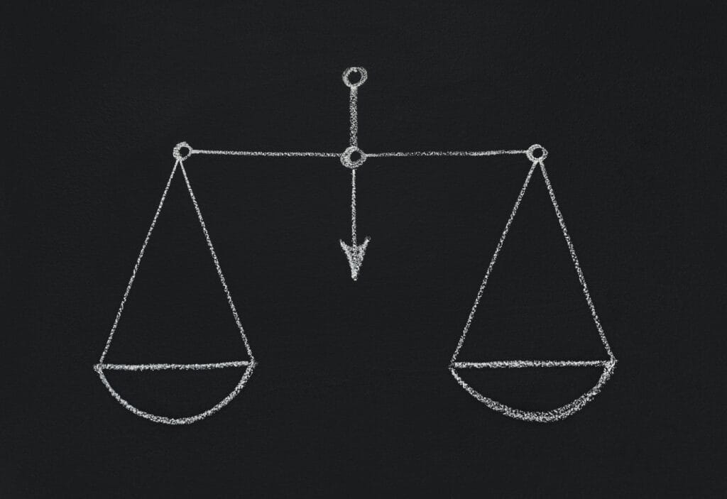 Drawn scales with empty cups on chalkboard