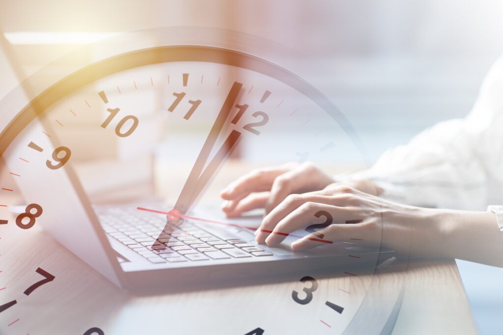 Business working times concept people work typing on laptop computer overlay with in time clock to l